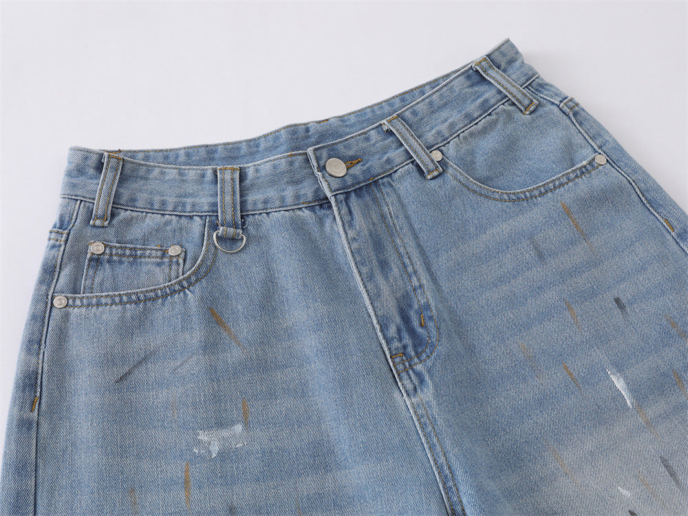 Full-length view of paint splatter denim culotte shorts styled on a model