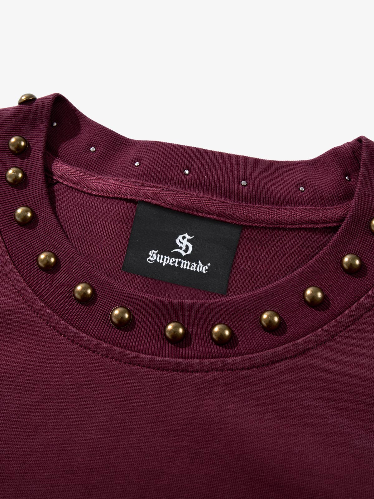 Detailed view of the flame print and stud accents on the T-shirt