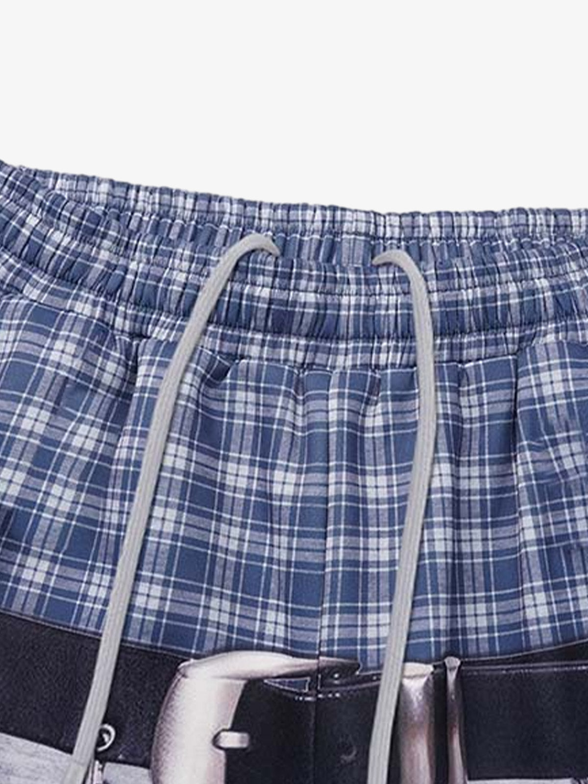 Close-up of the plaid waistband and graphic detail on the sweatpants