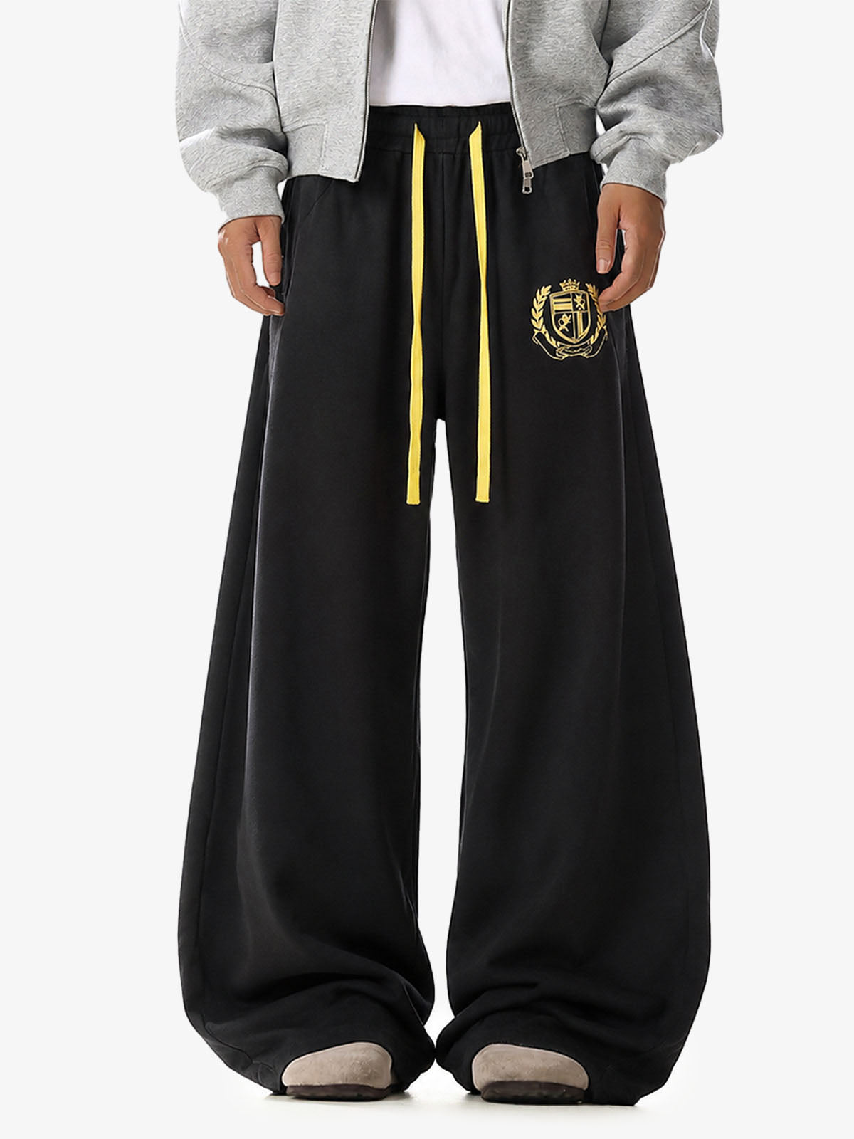 Wide-leg sweatpants with crest graphic shown from the back