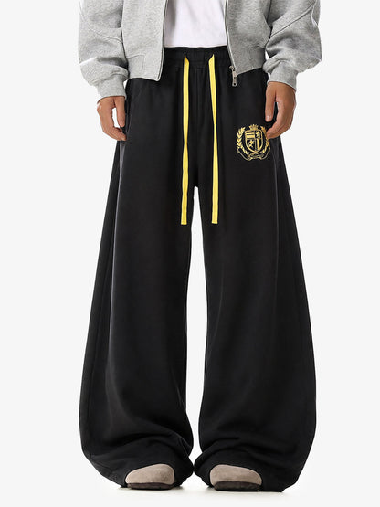 Wide-leg sweatpants with crest graphic shown from the back
