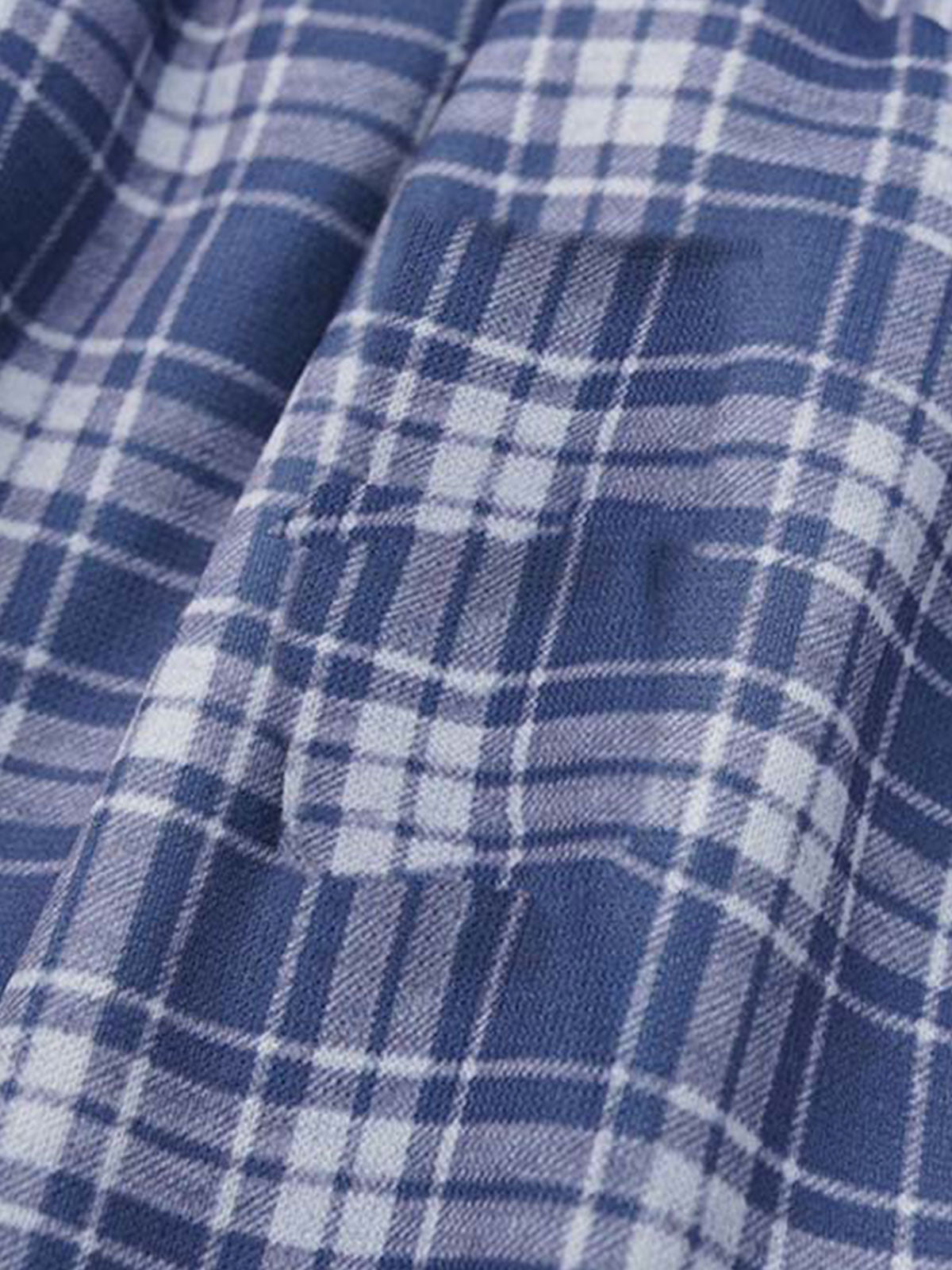 Back view of graphic sweatpants with a wide-leg cut and plaid waistband