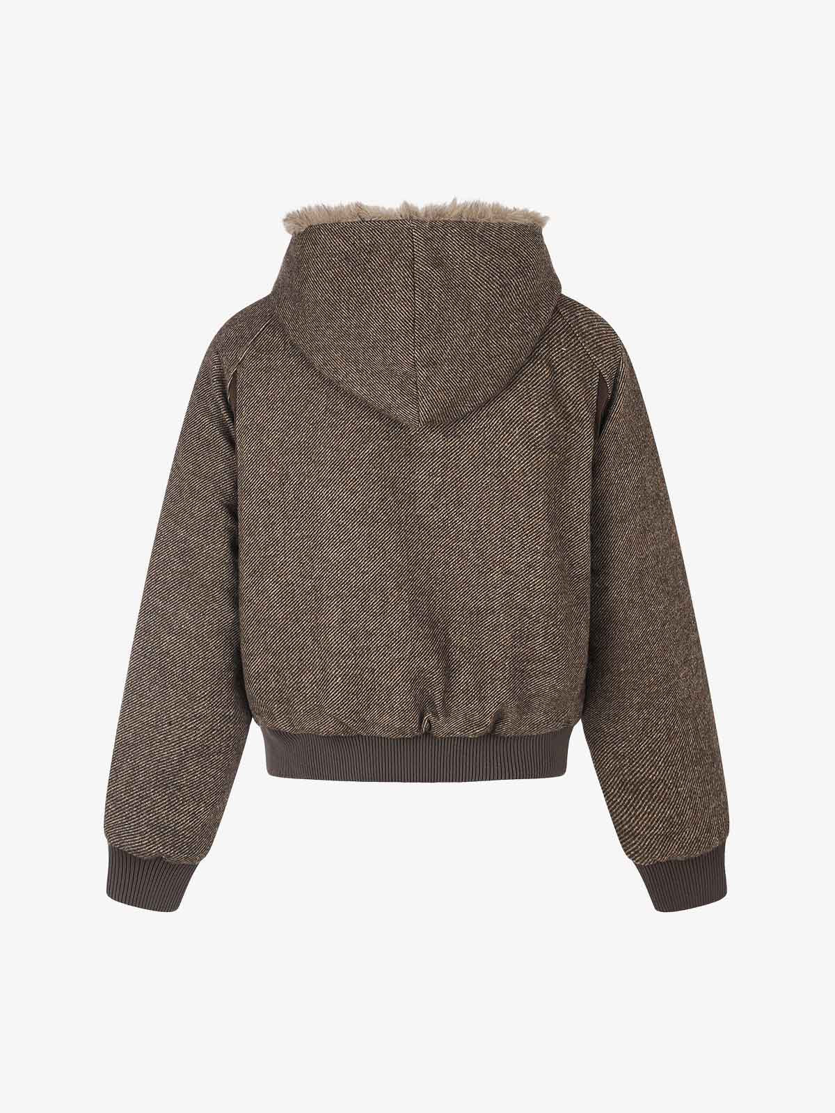 Three-quarter view of the faux-fur coat and asymmetric front