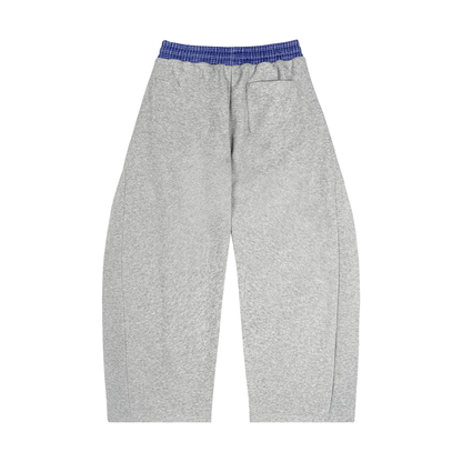 Close-up of the plaid waistband on barrel-leg sweatpants