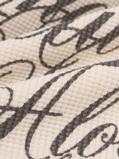 Close-up of the printed lettering on the casual long-sleeve top