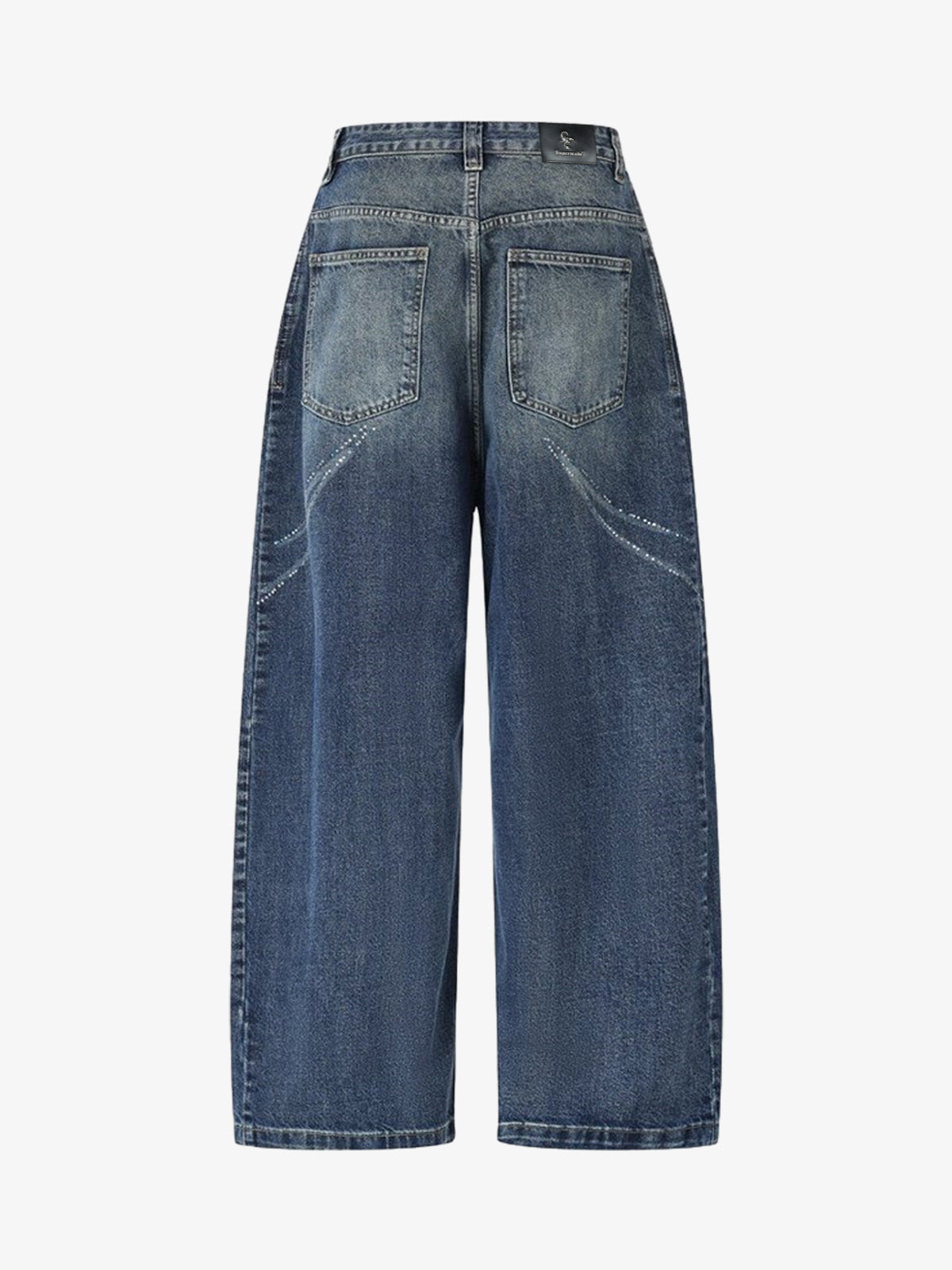Close-up of butterfly rhinestone detailing on the front of the jeans
