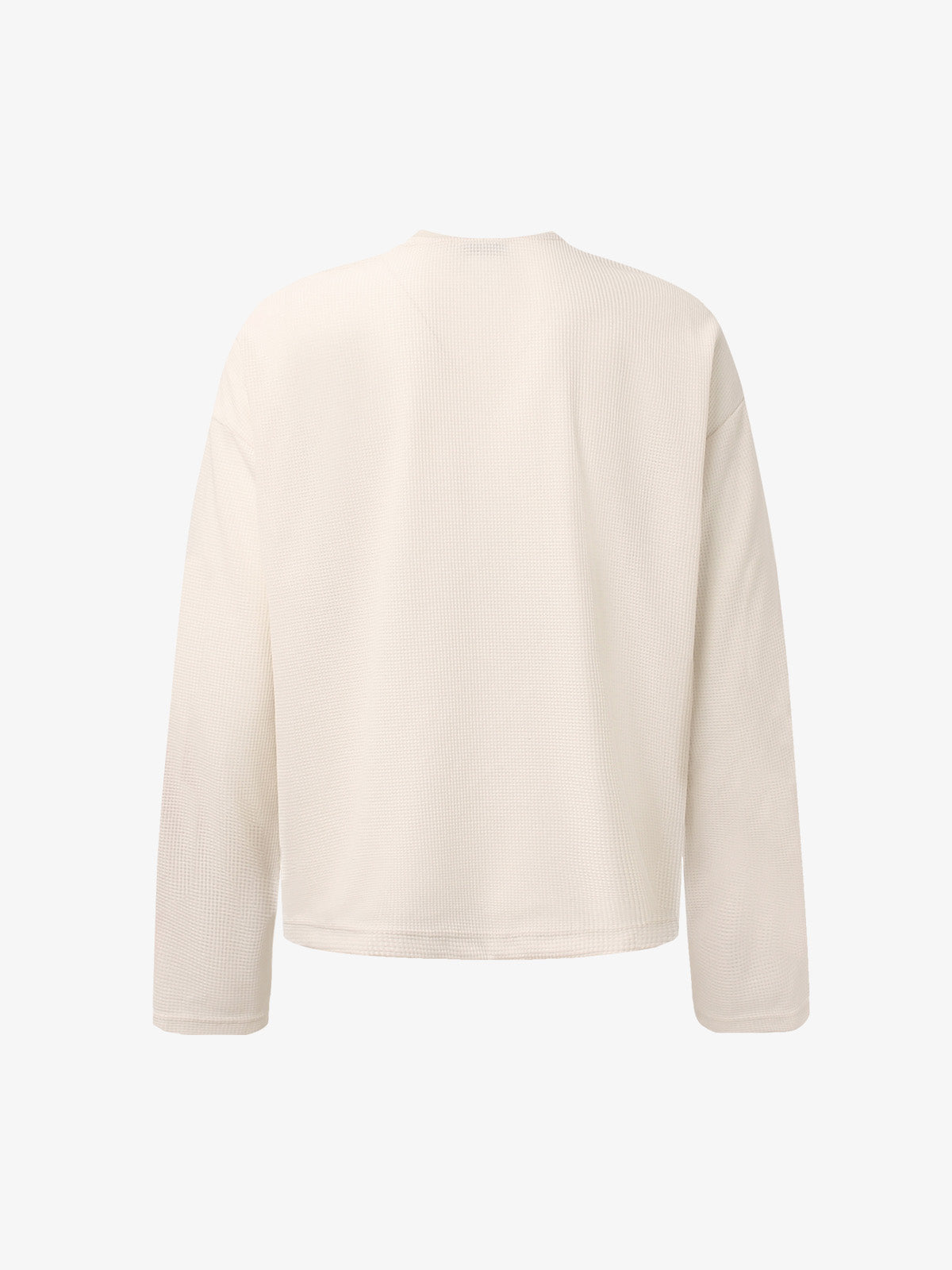 Side view of the waffle-knit top with relaxed long sleeves
