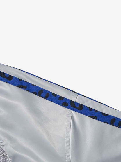 Full-length view of the butterfly satin jacket styled as a statement layer