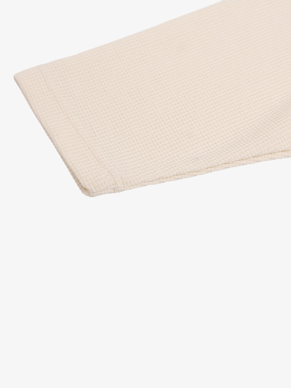 Waffle-knit long-sleeve top displayed flat to show its shape