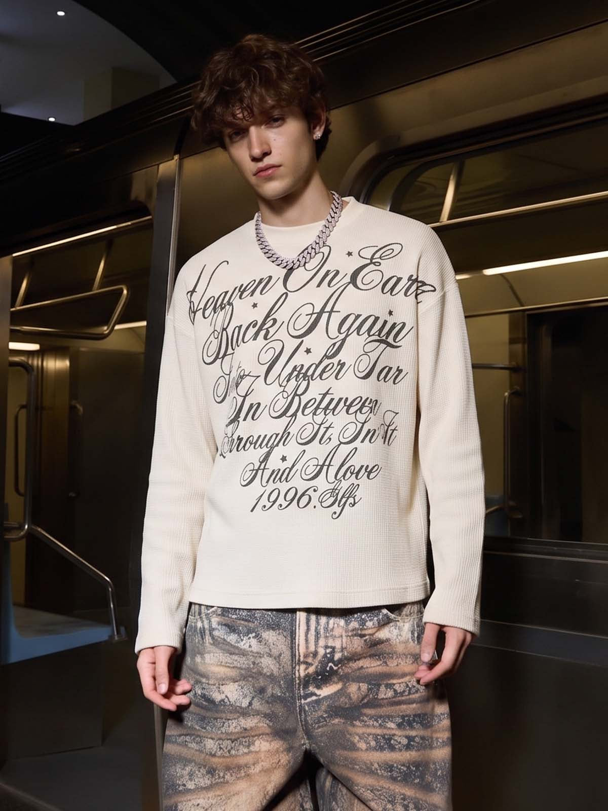 Long-sleeve top showing the script print across the chest