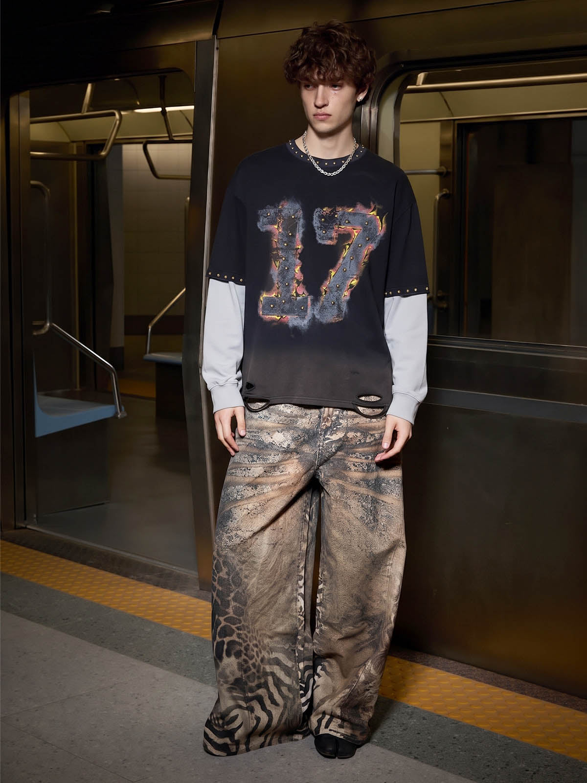 Close-up of distressed patchwork detailing on the long sleeve T-shirt