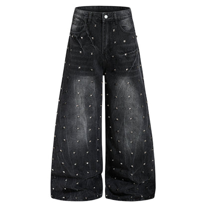 Front view of washed black baggy jeans with studded detailing