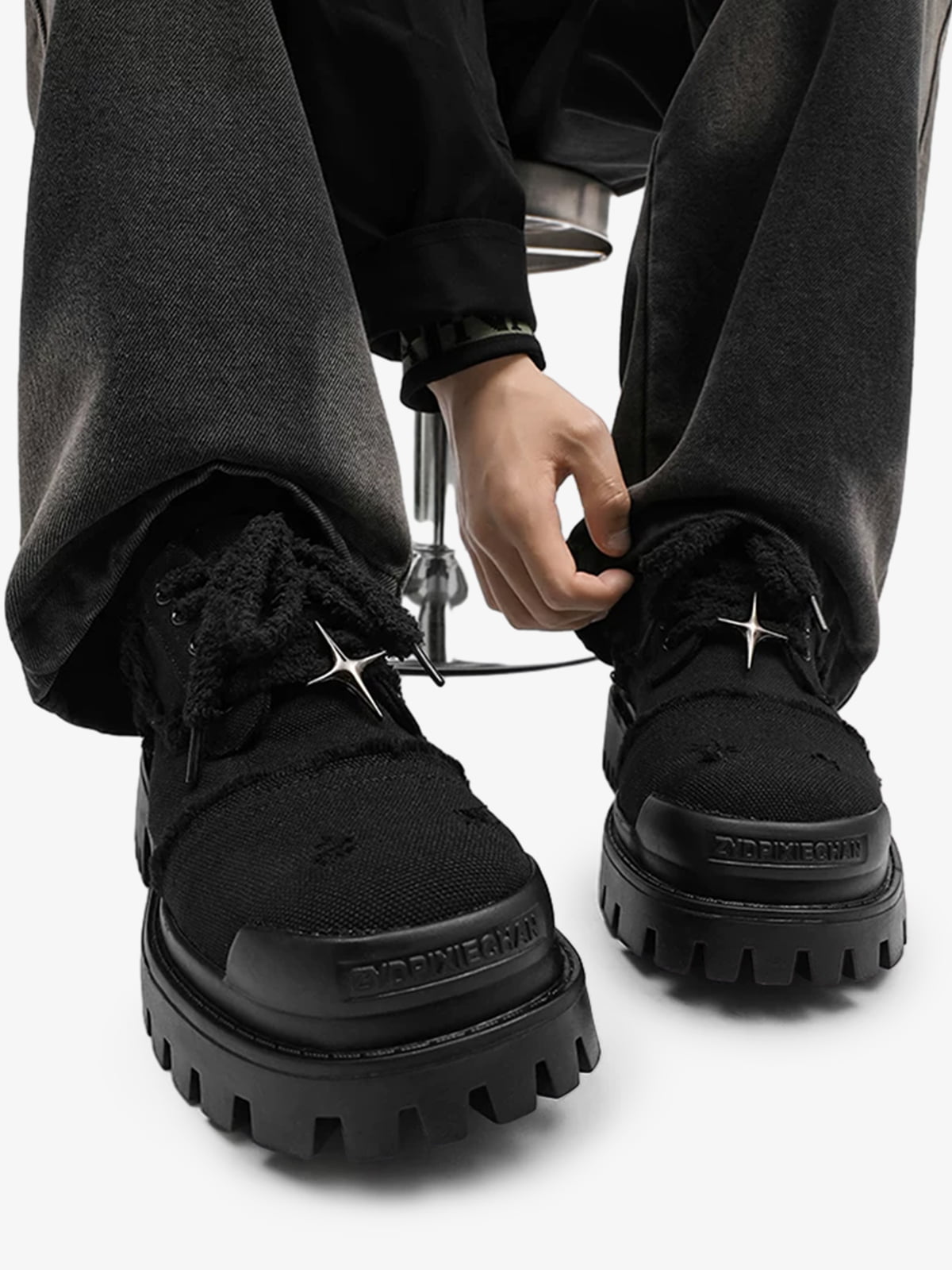 Side view of chunky denim trainers with star detailing