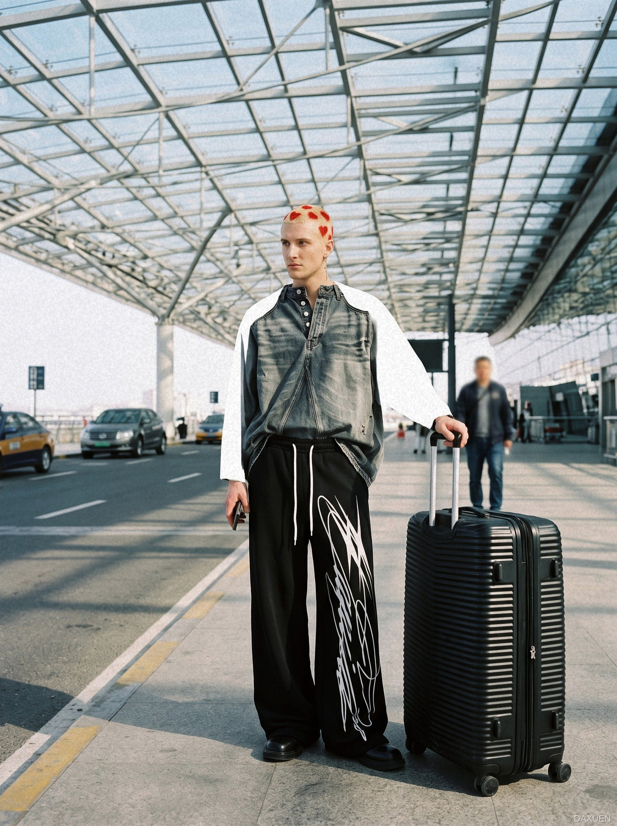 Wide-leg sweatpants shown from the front with a multi-line design