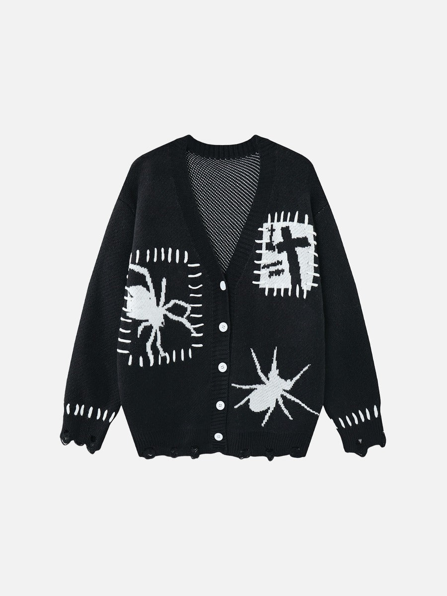 Black and white cardigan featuring an abstract spider and cross graphic