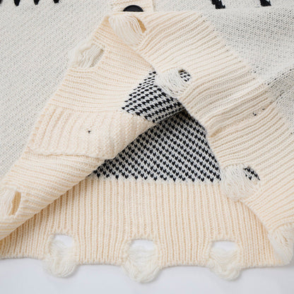 Detailed view of the abstract graphic pattern on the knitted cardigan
