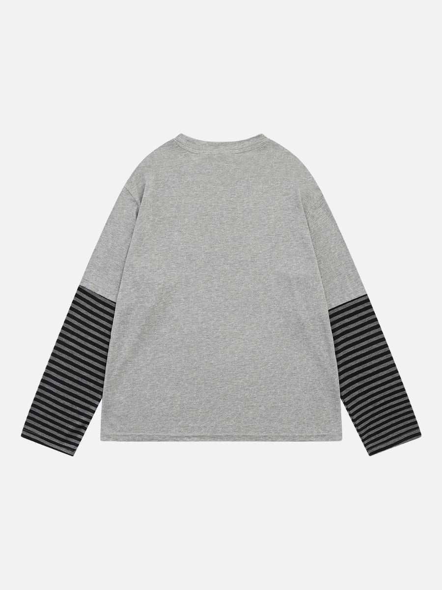 Front view of a long-sleeve T-shirt with a winged baroque design