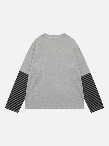 Front view of a long-sleeve T-shirt with a winged baroque design