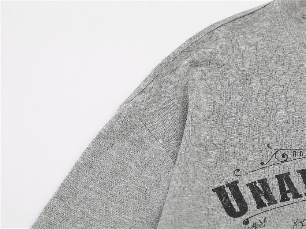 Ornate baroque winged design featured on the front of the T-shirt