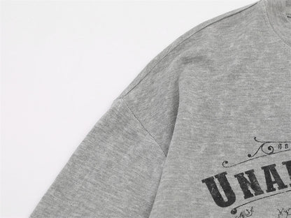 Ornate baroque winged design featured on the front of the T-shirt