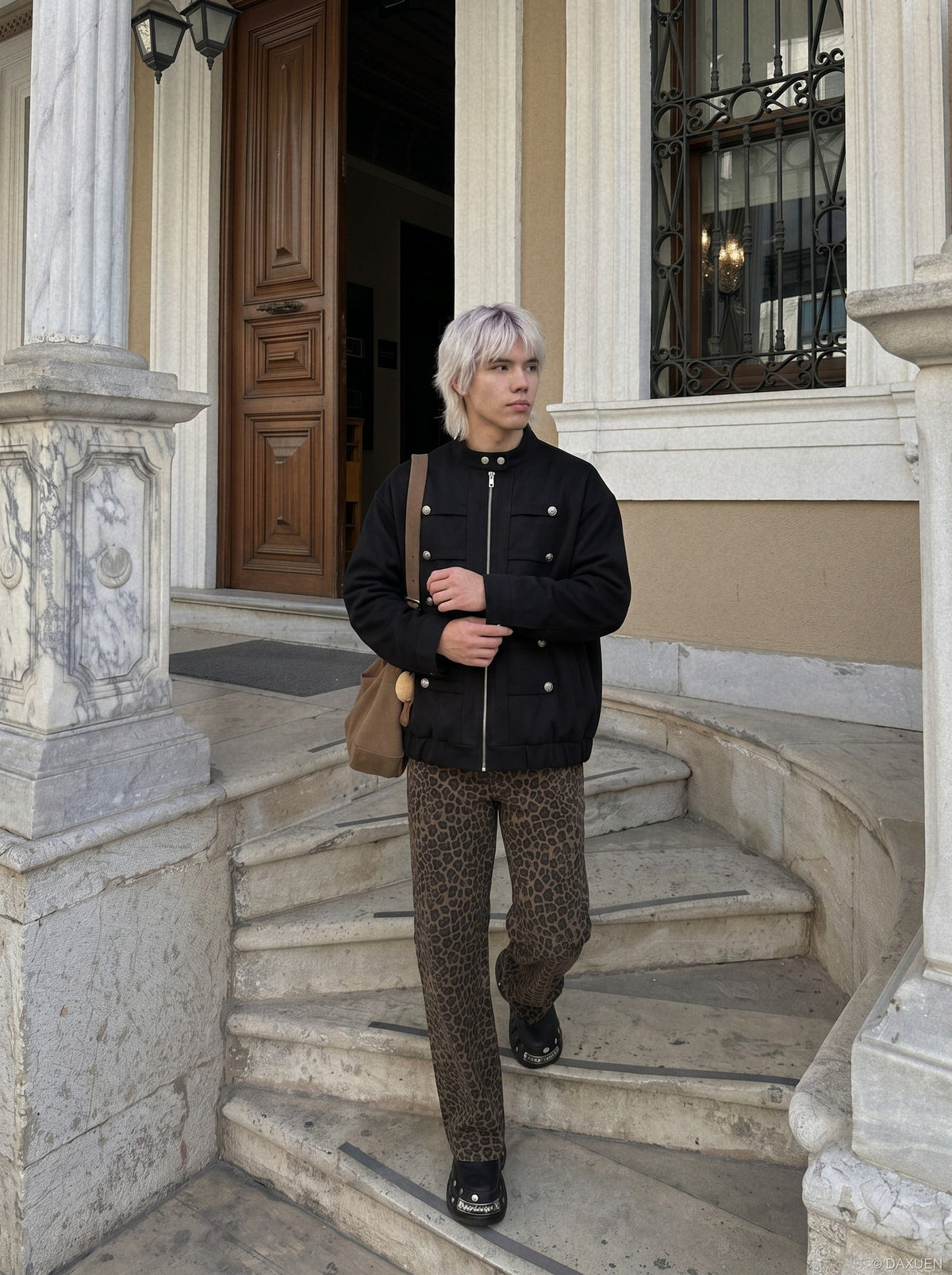 Front view of a black oversized jacket with silver buttons