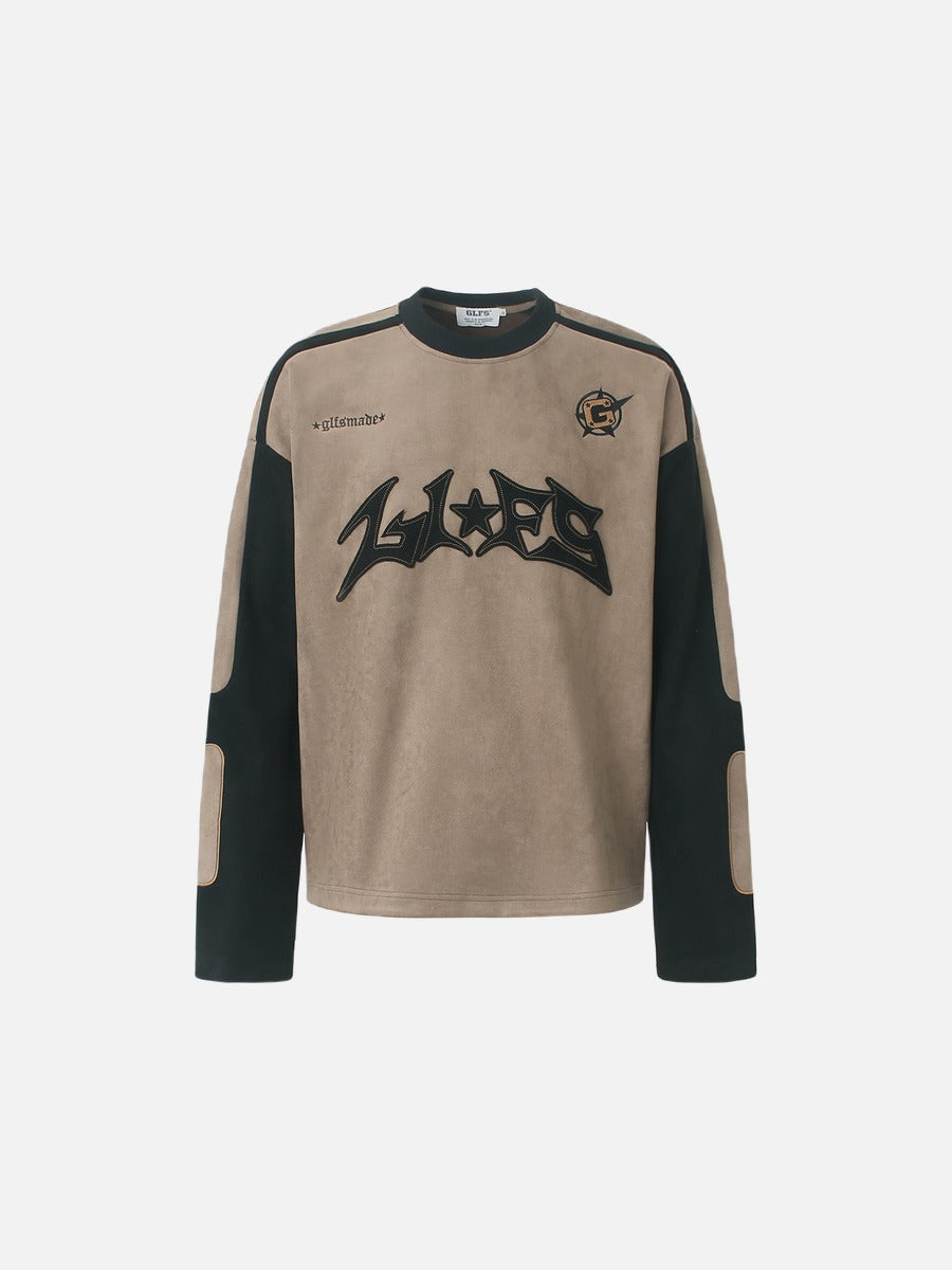 Front view of a graphic long-sleeve top with appliqué detail