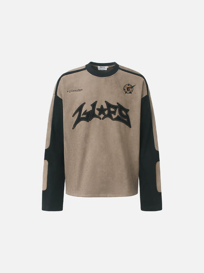 Front view of a graphic long-sleeve top with appliqué detail