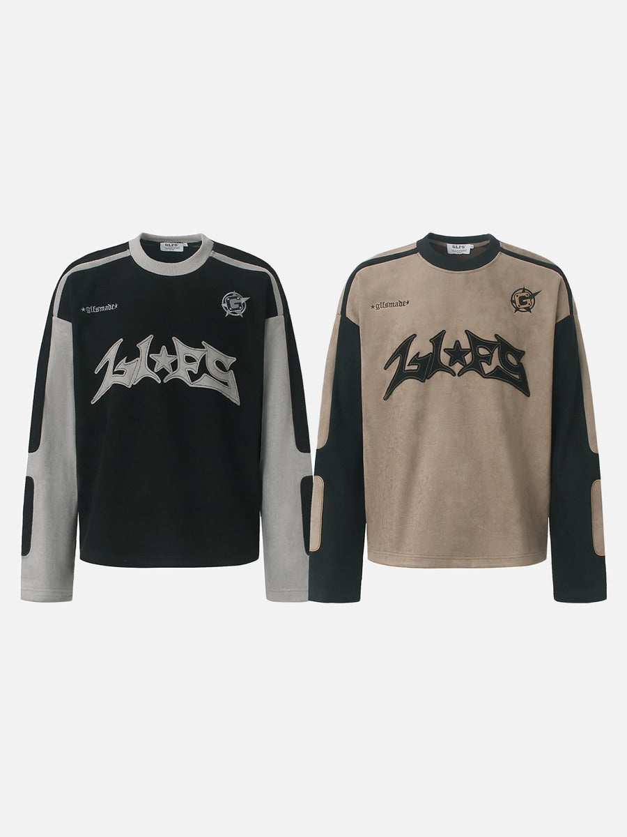 Casual long-sleeve top featuring a bold graphic appliqué