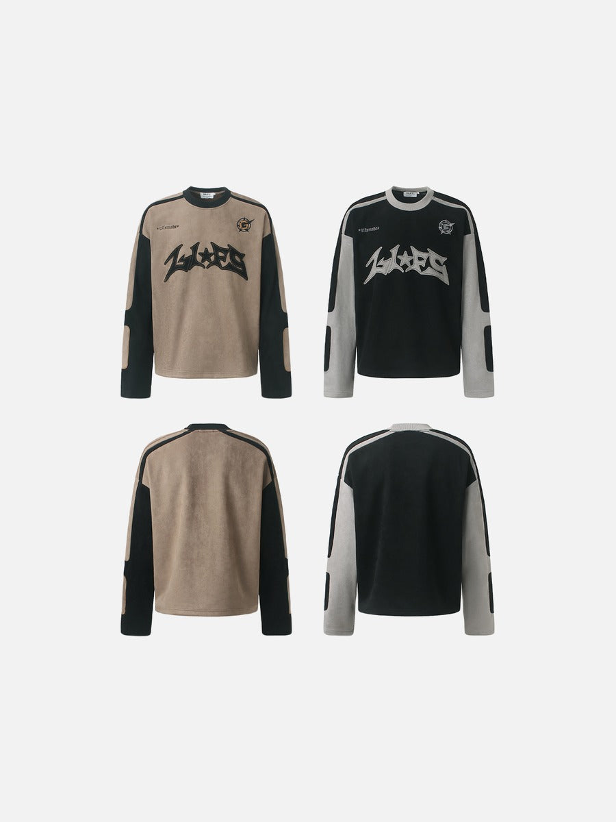 Appliqué detail displayed on the front of a graphic long-sleeve top