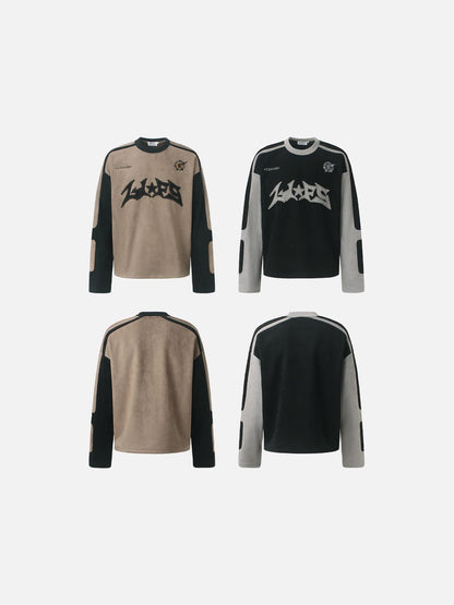 Appliqué detail displayed on the front of a graphic long-sleeve top