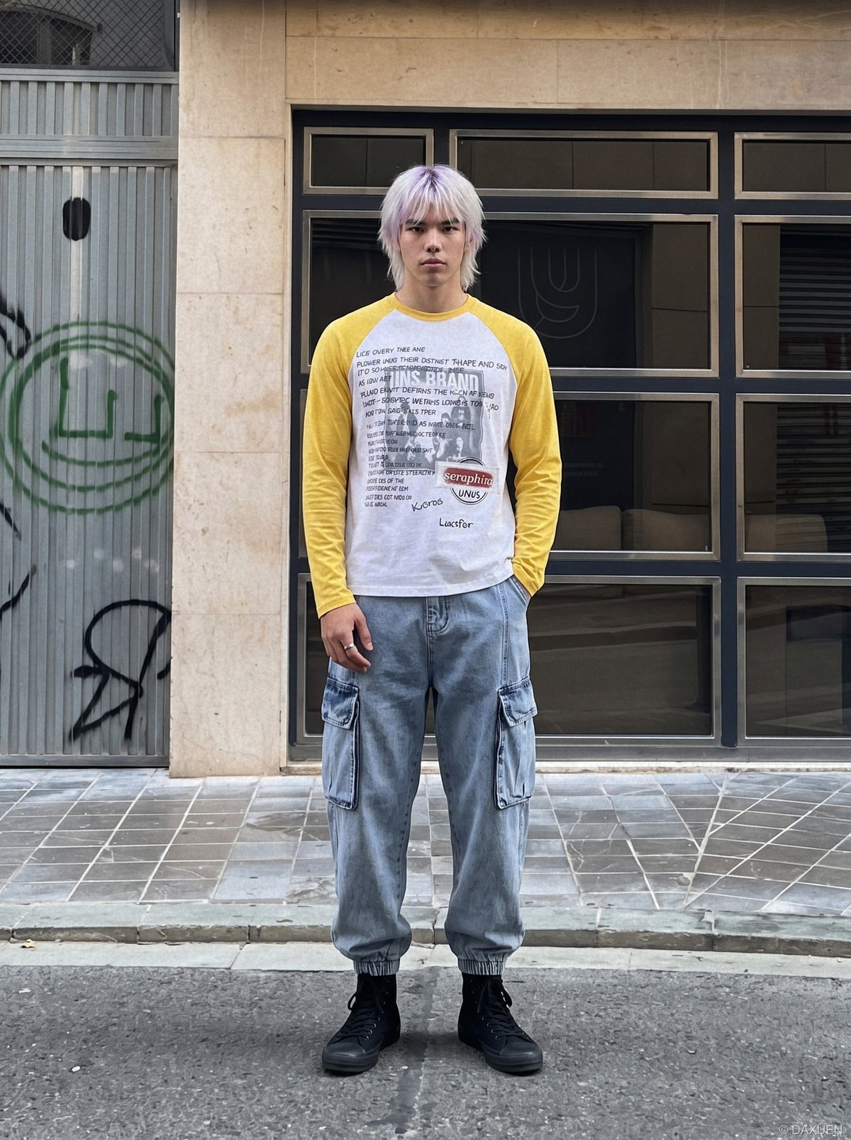 Close-up of the graphic print on a white and yellow raglan T-shirt