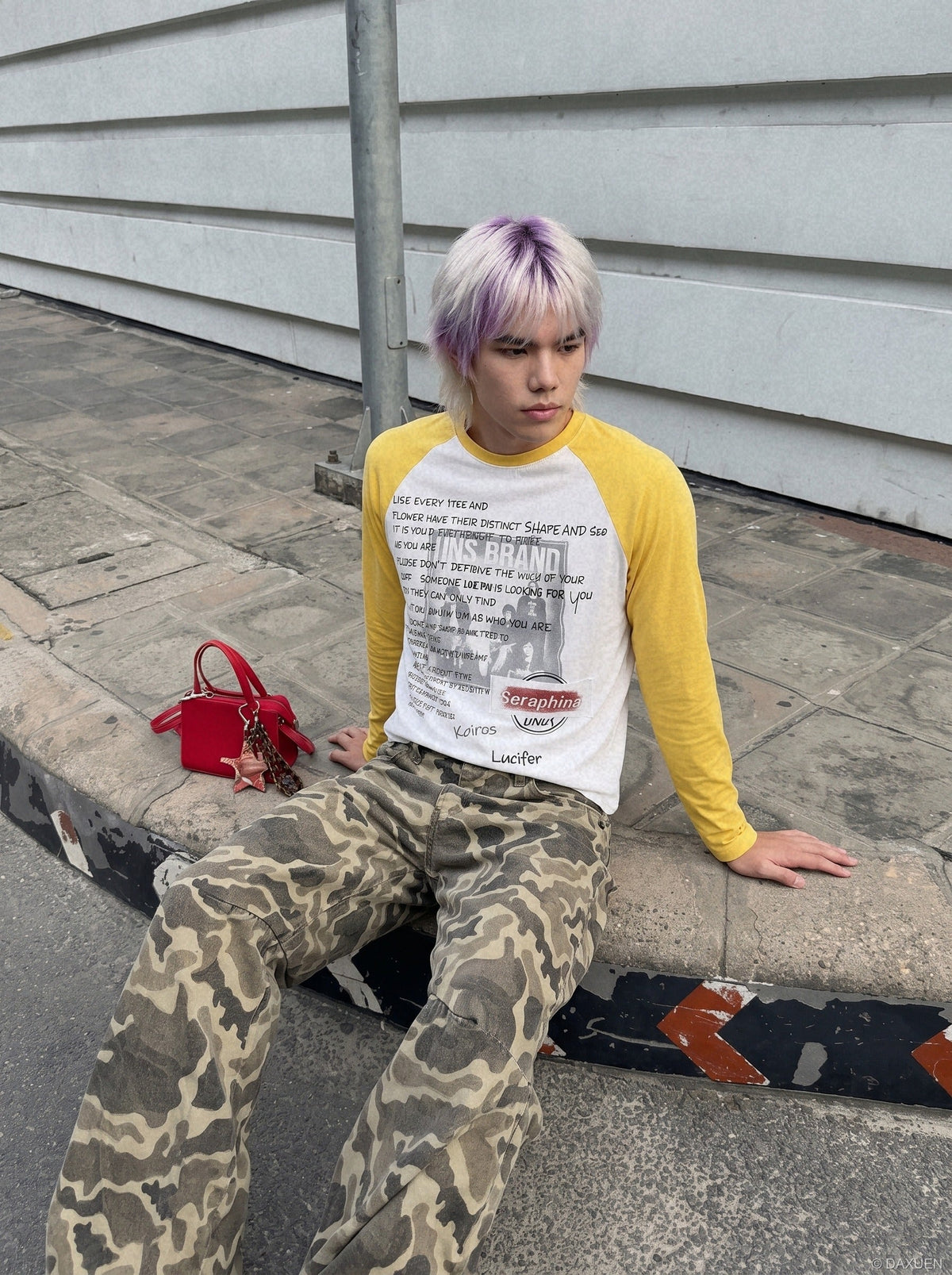 Side view of a white and yellow raglan T-shirt