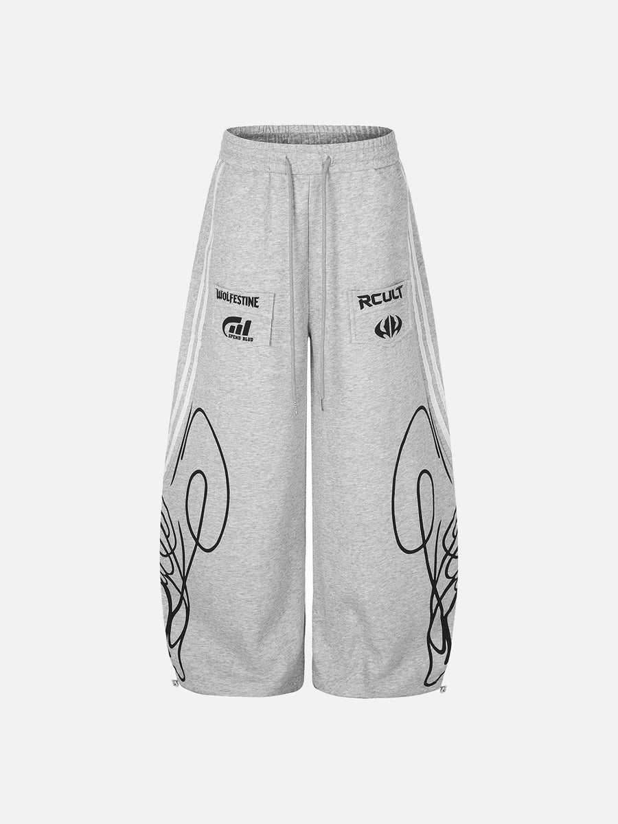 Black and grey graphic winged sweatpants shown from the front