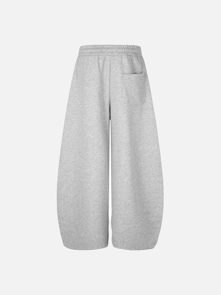 Side view of black and grey graphic winged sweatpants