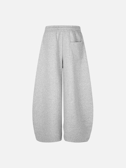 Side view of black and grey graphic winged sweatpants