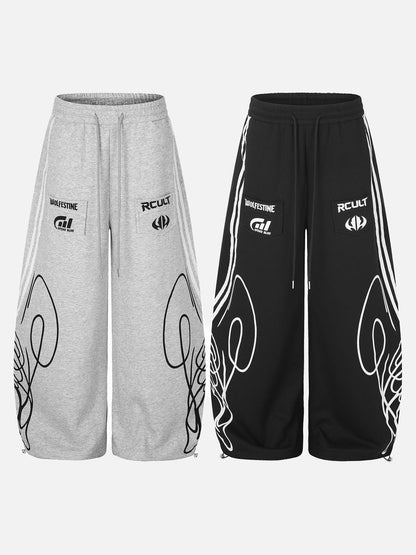 Black and grey sweatpants showing the relaxed leg shape and graphic print