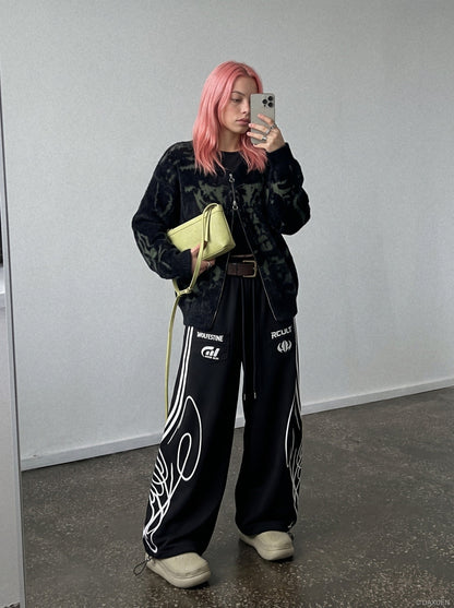 Black and grey graphic sweatpants displayed against a plain background
