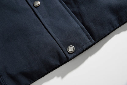 Side view of a navy jacket with a contrast collar