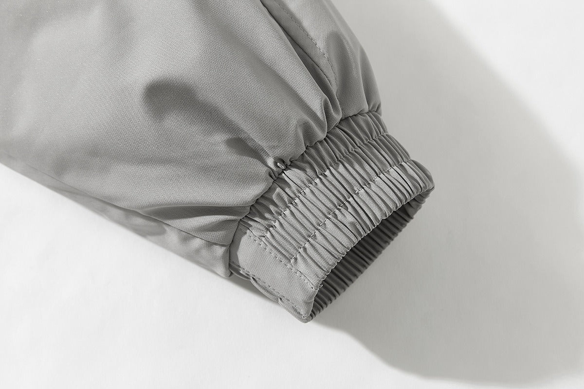 Detail of the light grey padded bomber jacket sleeve
