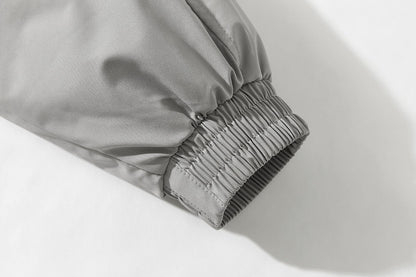 Detail of the light grey padded bomber jacket sleeve