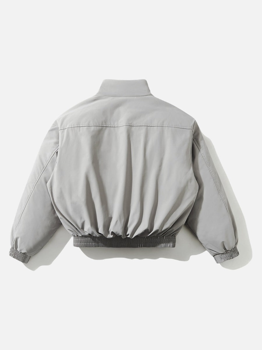 Cropped light grey jacket styled for everyday layering