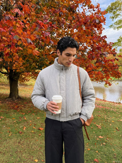 Close-up of the light grey padded bomber jacket collar and zip