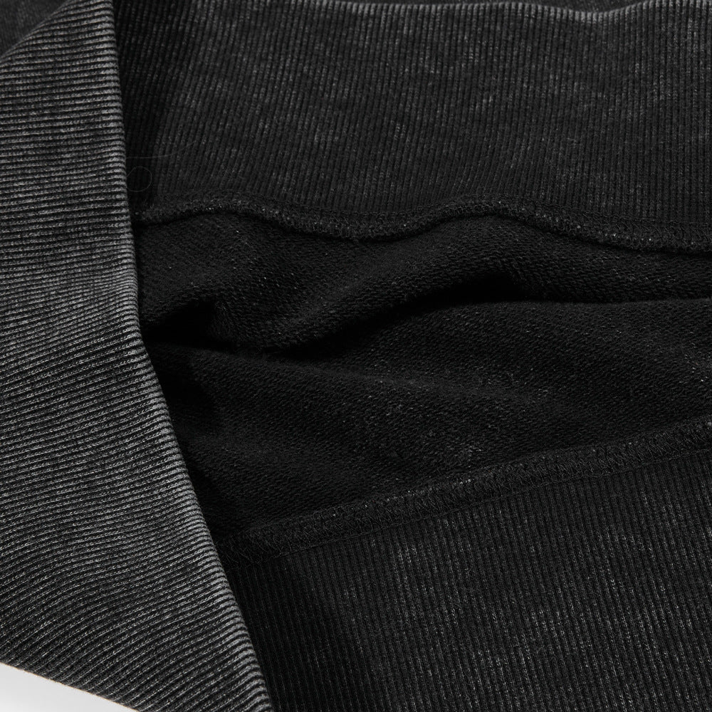 Detail of the neckline and shoulder seams on a charcoal sweatshirt