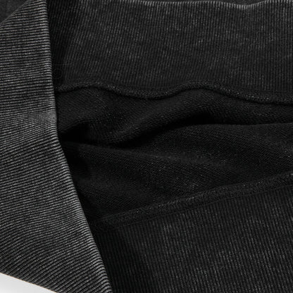 Detail of the neckline and shoulder seams on a charcoal sweatshirt