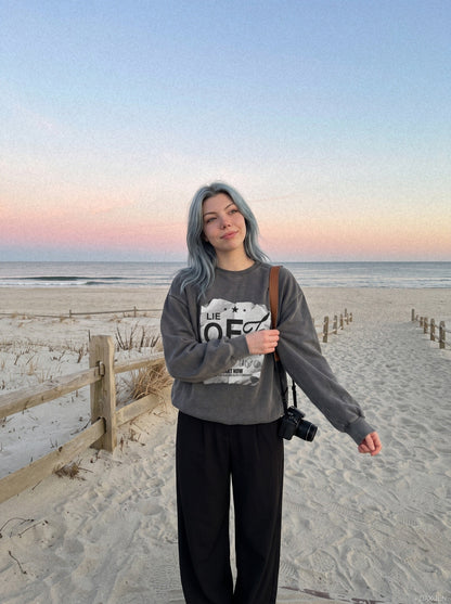 Close-up of the crumpled graphic print on a charcoal sweatshirt