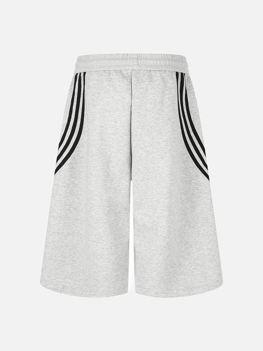 Side view of striped wide-leg shorts with curved stripe detailing
