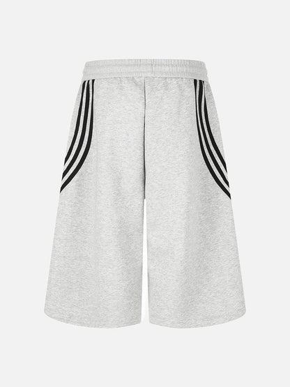 Side view of striped wide-leg shorts with curved stripe detailing