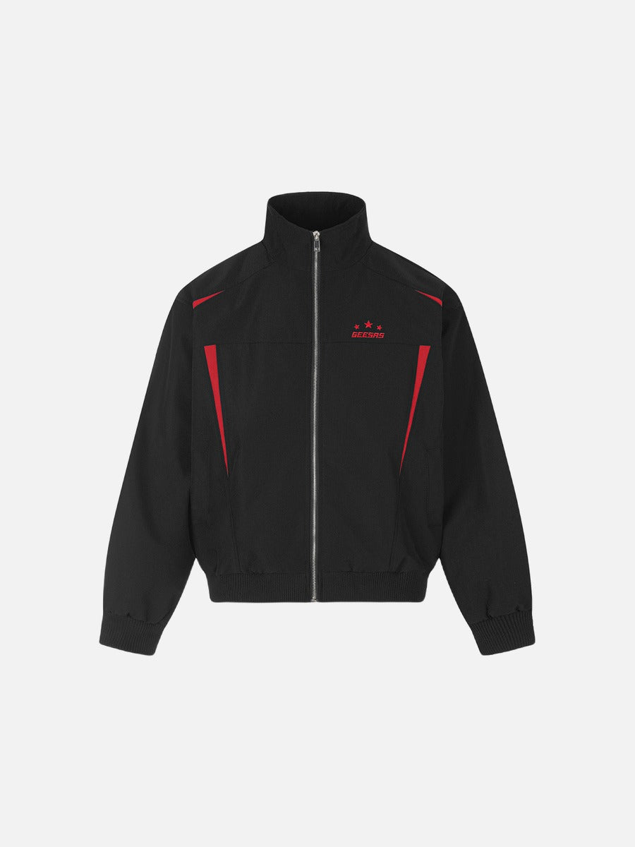 Red tracksuit top with black panels and star graphic detail