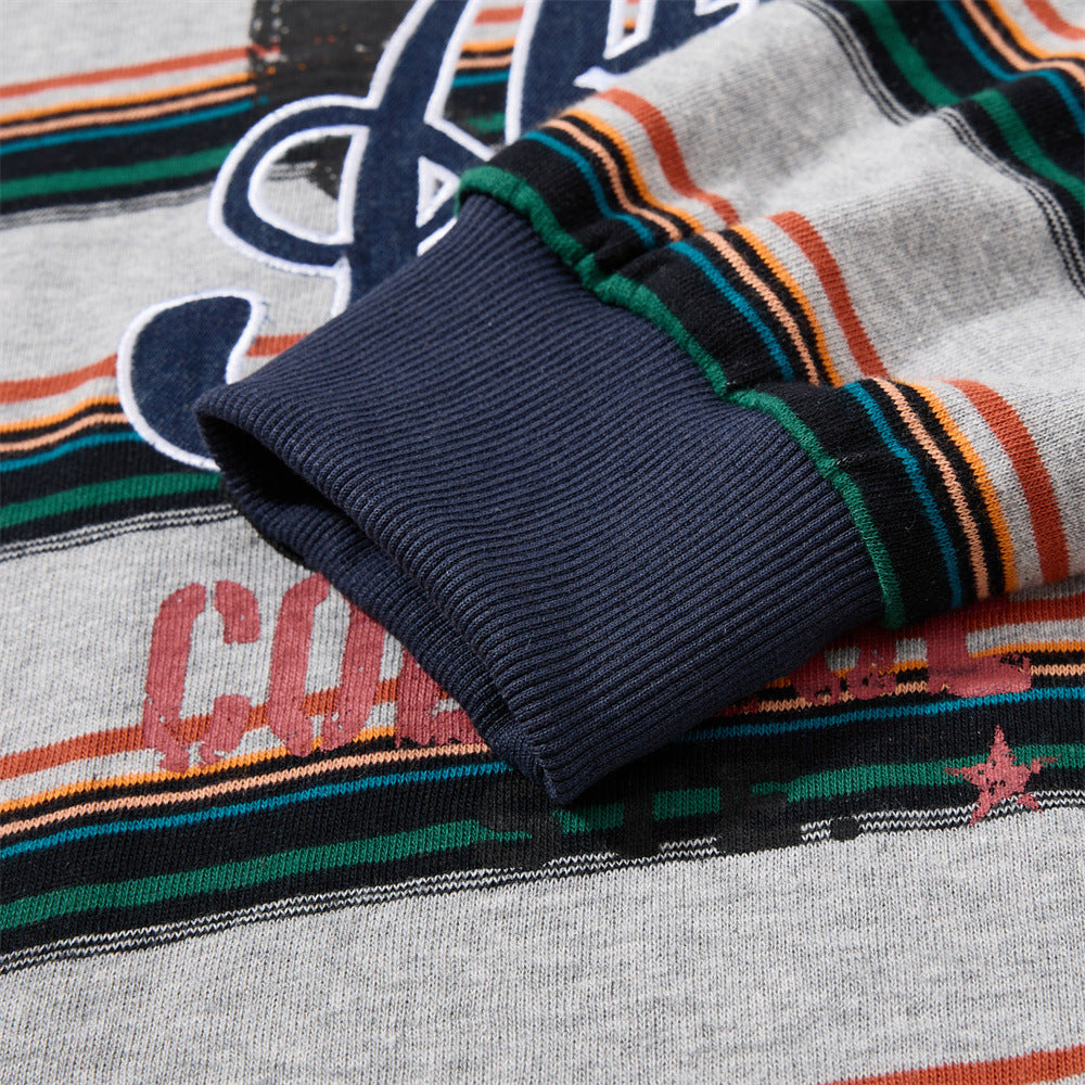 Detail of the short sleeve and stripe pattern on the oversized polo shirt