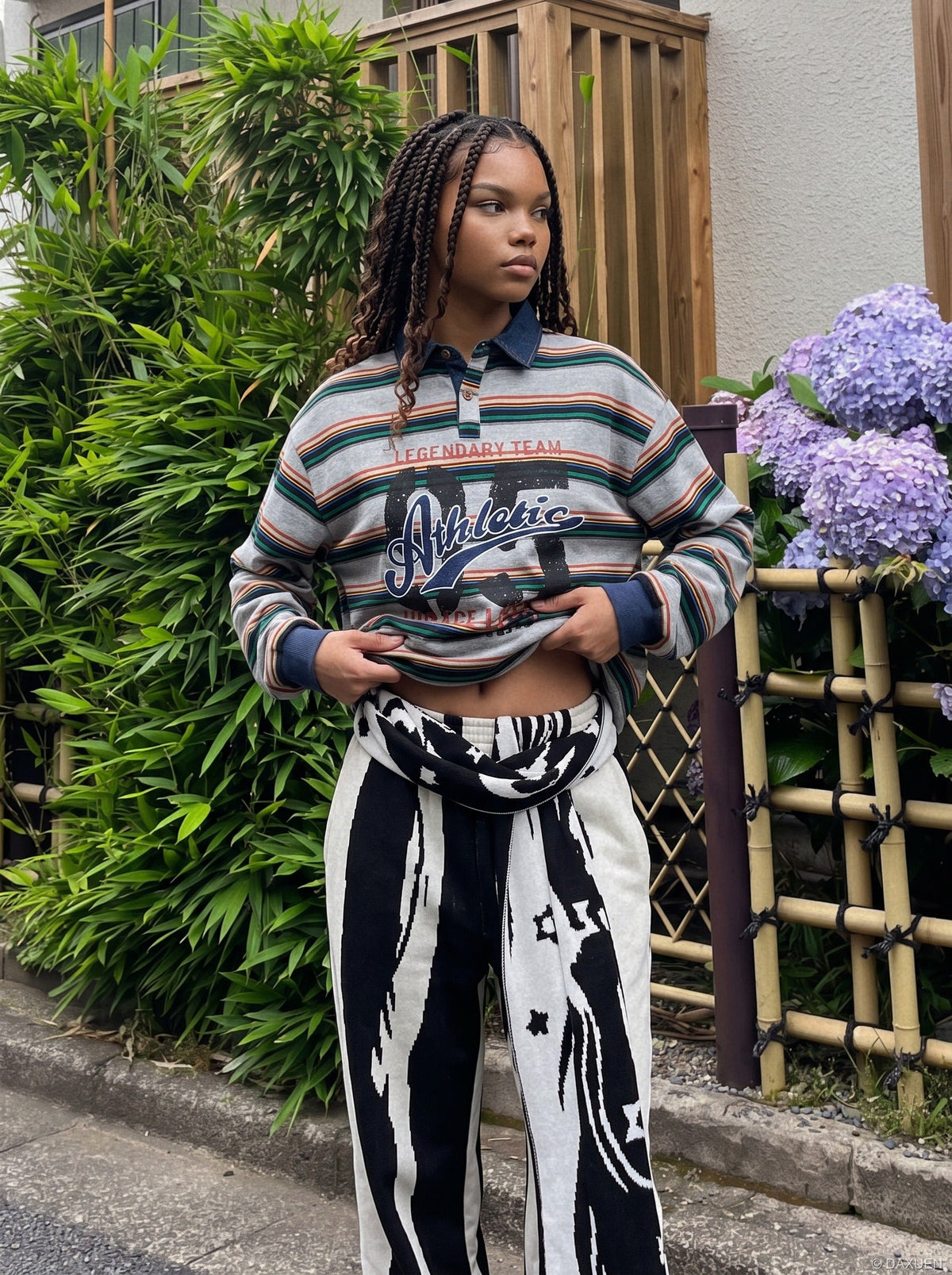 Oversized striped graphic polo shirt shown on a model from the front